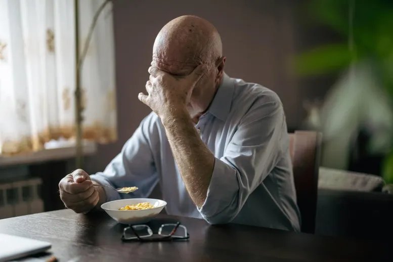 Why Eating Alone Could Be Surprisingly Dangerous for Older Adults Depressed Senior Man Eating Breakfast Alone